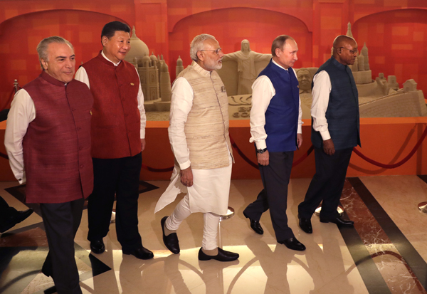 Leaders of BRICS nations (from left) Brazilian President Michel Temer, Chinese President Xi Jinping, Indian Prime Minister Narendra Modi, Russian President Vladimir Putin and South African President Jacob Zuma walk past sand sculptures of famous landmarks of BRICS nations created by Indian sand artist Sudarsan Pattnaik, prior to dinner hosted by Modi in Goa, India, on Saturday (AP photo)