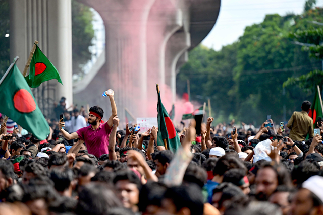 Anti-government protestors wave Bangladesh's national flag as they celebrate at Shahbag area, near Dhaka University in Dhaka on Monday (AFP photo)