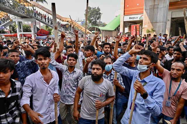 Garment workers block roads as they take part in a protest in Dhaka on Wednesday (AFP photo)