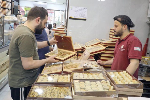 Sweets are a key ingredient to Eid Al Fitr, which marks the end of the holy month of Ramadan. Visiting relatives and friends and exchanges of sweets are indispensable parts of the festive occasion (Photo by Osama Aqarbeh)