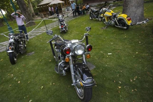 An Iranian visitor takes photograph of Harley Davidson motorcycles during the Tehran Classic Car Show 09 at Niavaran palace in northern Tehran on July 21, 2009 (Reuters photo)