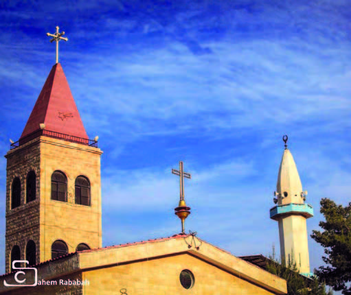 A mosque and a church are recently seen side-by-side in Ermeimin town, some 25km northwest of Amman (Photo by Sahem Rababah)