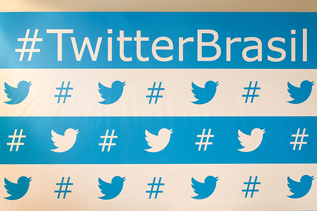 Twitter’s brand marks are seen as background of the speakers during their press conference in Sao Paulo, Brazil, on February 20, 2013 (AFP photo)