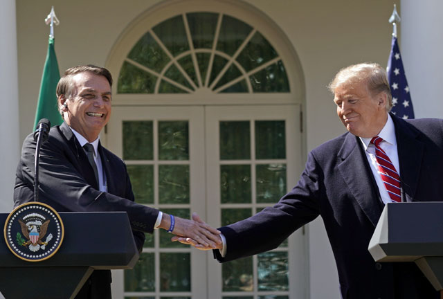 Brazil's President Jair Bolsonaro shakes hands with US President Donald Trump at the conclusion of a joint news conference in the Rose Garden of the White House in Washington, US, on Tuesday (Reuters photo)
