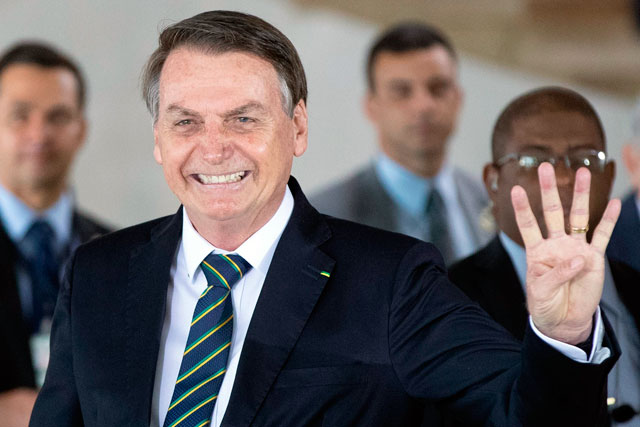 Brazil's President Jair Bolsonaro gestures as he welcomes leaders of the BRICS emerging economies at the Itamaraty palace on Thursday in Brasilia, Brazil (AFP photo)