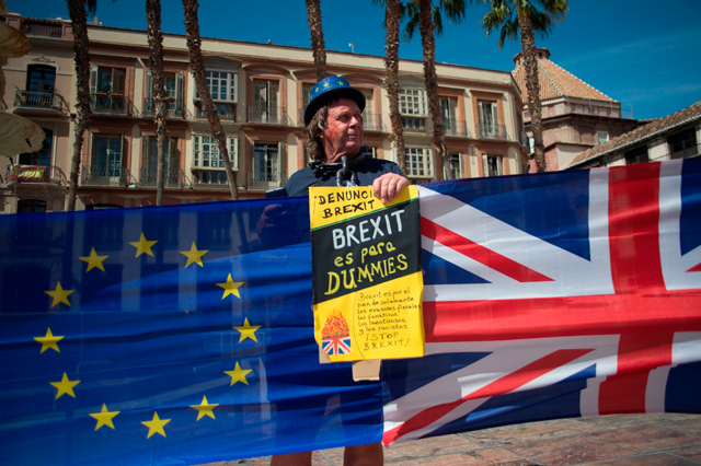 A man holds an European Union and British flags during a protest against Brexit in Malaga on Sunday (AFP photo)