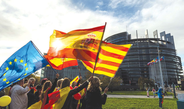 Women hold Spanish, Catalan and European flags during a demonstration against Catalonia's independence in front of the European Parliament building in Strasbourg, eastern France, on Tuesday (AFP photo)