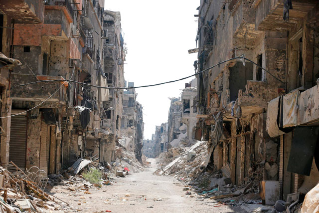 Destroyed buildings are seen in the Yarmouk Palestinian refugee camp in the Syrian capital Damascus as the regime began to clean the wreckage from the camp on Tuesday (AFP photo)