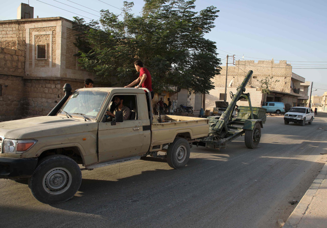 Syrian rebel-fighters with the National Liberation Front tow an artillery in northwestern countryside of Aleppo province on Tuesday (AFP photo)