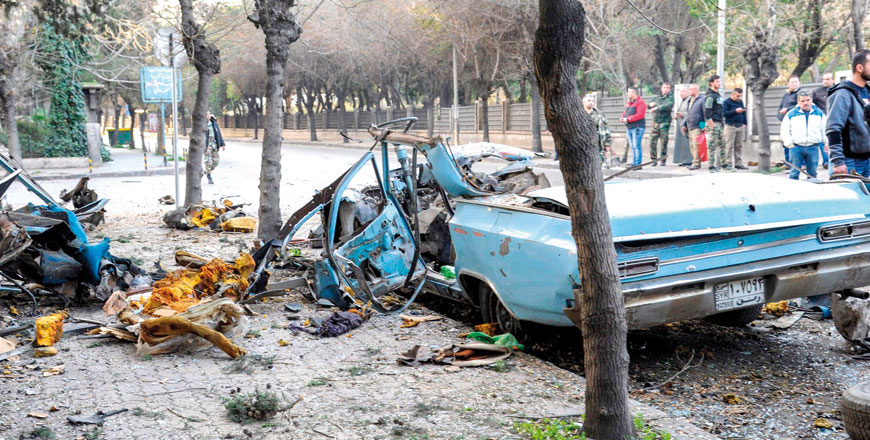 Thi handout photo released by the official Syrian Arab News Agency on Thursday shows people looking at the remains of a car which exploded following a bomb attack near the Russian embassy in the Syrian capital Damascus, in the second such blast in Damascus in less than a week (AFP photo)