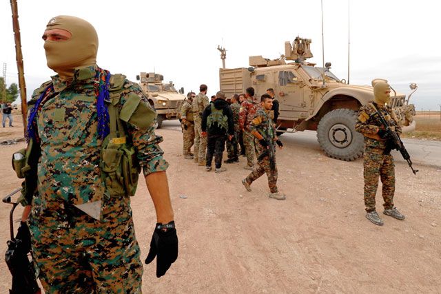 US forces and members of the Syrian Democratic Forces patrol the Kurdish-held town of Al Darbasiyah in northeastern Syria bordering Turkey on November 4 (AFP photo)