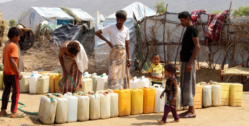 Displaced Yemenis from Hodeida fill their water barrels at a makeshift camp in a village in the northern district of Abs in Hajjah province on Sunday (AFP photo)