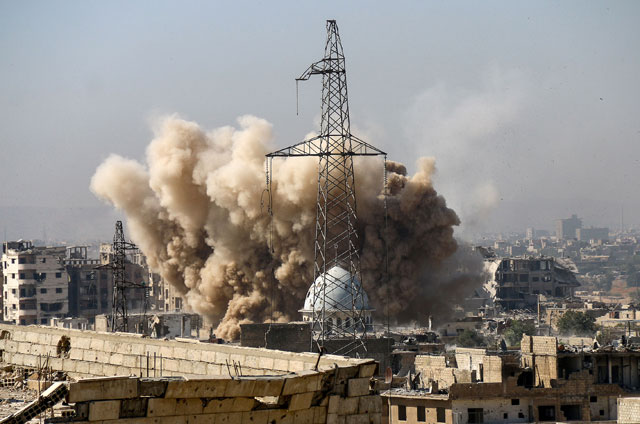 A huge explosion sends clouds into the air after government forces reportedly carried out air strikes over Sakba district in the Eastern Ghouta region of Damascus, Syria, on Monday (Anadolu Agency photo)