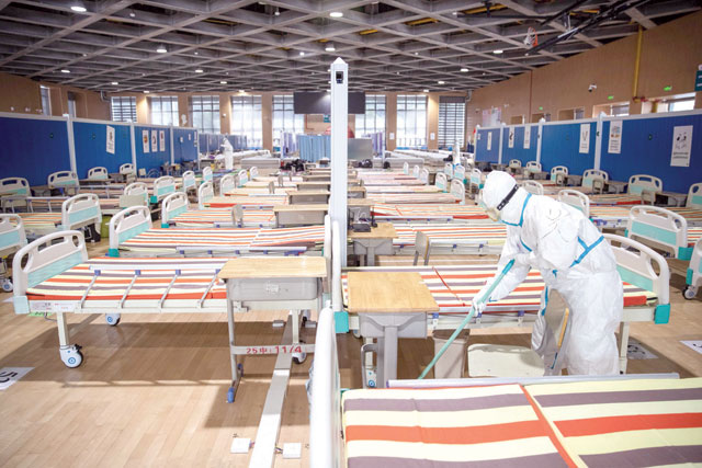 This photo taken on Tuesday shows a medical staff member cleaning the floor after all patients were discharged at a temporary hospital set up to treat people with the COVID-19 coronavirus in Wuhan in China's central Hubei province (AFP photo)