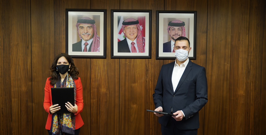 CPF CEO Tamam Mango, NIMD's resident representative in Amman Rami Adwan pose for a photo during a signing ceremony on Sunday (Petra photo)