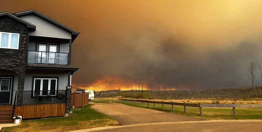This handout image courtesy of Kosar shows smoke and flames from the fire in Fort McMurray, ALberta, Canada on Tuesday as residents from the area of Abasand Heights evacuate the area (AFP photo /handout /KOSAR)