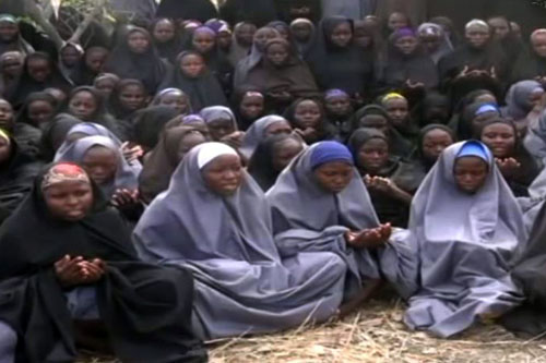 This file photo taken on May 12, 2014, shows a screengrab taken from a video of Nigerian extremist group Boko Haram obtained by AFP showing girls wearing the full-length hijab and praying in an undisclosed rural location (AFP photo)