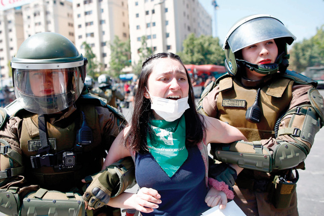 Riot police detain a demonstrator during a protest in Santiago, Chile, on Monday (AFP photo)