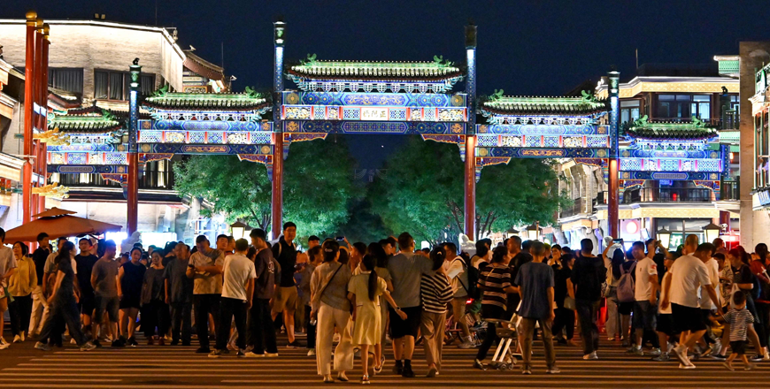 People walk at the Qianmen Street in Beijing on Tuesday (AFP photo)