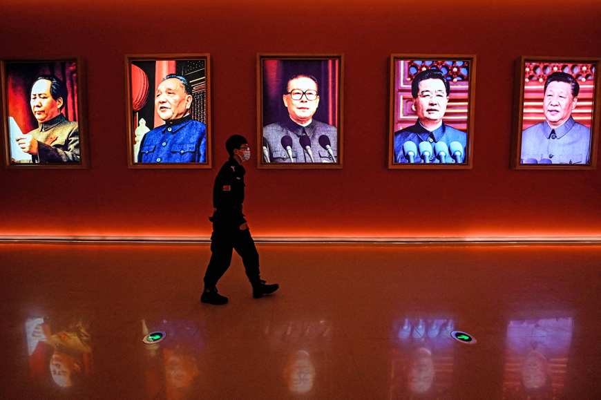This file photo taken on October 15 shows a man walking past portraits of (from left to right) late Chinese chairman Mao Zedong and former Chinese leaders Deng Xiaoping, Jiang Zemin, Hu Jintao and current president Xi Jinping at Yan’an Revolutionary Memorial Hall in Yan’an city, China’s northwest Shaanxi province, on the eve of the 20th Communist Party Congress (AFP photo)