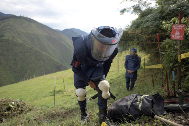 Colombian soldiers of Humanitarian Demining Battalion work inside a minefield laid by guerrillas in Marquetalia, the birthplace of the Revolutionary Armed Forces of Colombia, Tolima Department, Colombia, on October 27 (AFP photo)
