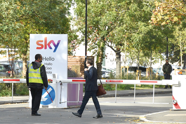 A man walks past the entrance to the offices of television broadcaster Sky in Ilseworth, west London, on Saturday (AFP photo)