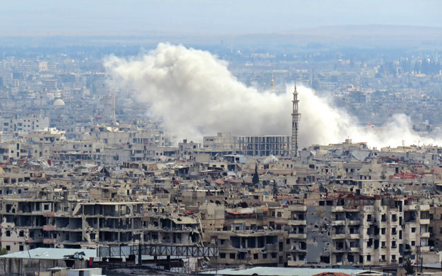 A general view taken from a government-held area in Damascus shows smoke rises from the rebel-held enclave of Eastern Ghouta on the outskirts of the Syrian capital, following fresh air strikes and rocket fire on Tuesday (AFP photo)