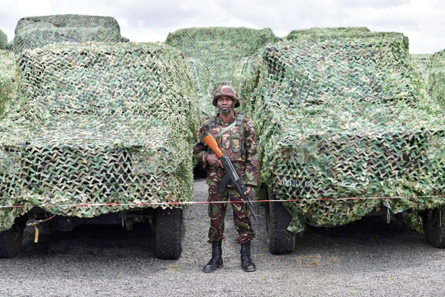 A Kenya Defence Forces soldier stands next to military vehicles while attending a flag presentation ceremony by Kenya’s President William Ruto before they deploy to the Democratic Republic of the Congo as part of the East Africa Community Regional Force at the Embakasi Garrison in Nairobi, on Wednesday (AFP photo)
