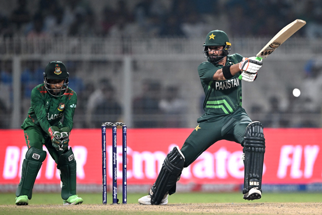 Pakistan’s Iftikhar Ahmed (right) plays a shot as Bangladesh’s wicketkeeper Mushfiqur Rahim watches during the 2023 ICC Men’s Cricket World Cup one-day international (ODI) match between Pakistan and Bangladesh at the Eden Gardens in Kolkata on Tuesday (AFP photo)