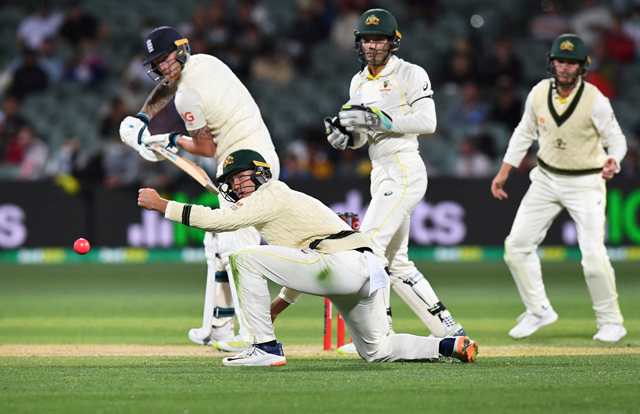 Australia's Marnus Labuschagne (second left) attempts to field a shot from England batsman Ben Stokes (left) on the fourth day of the second Ashes cricket Test match in Adelaide on Sunday (AFP photo)