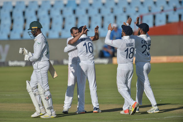 South Africa's Kagiso Rabada (left) walks back to the pavilion after his dismissal by India's Mohammed Shami (second left) during the third day of the first Test cricket match between South Africa and India at SuperSport Park in Centurion on Tuesday (AFP photo)