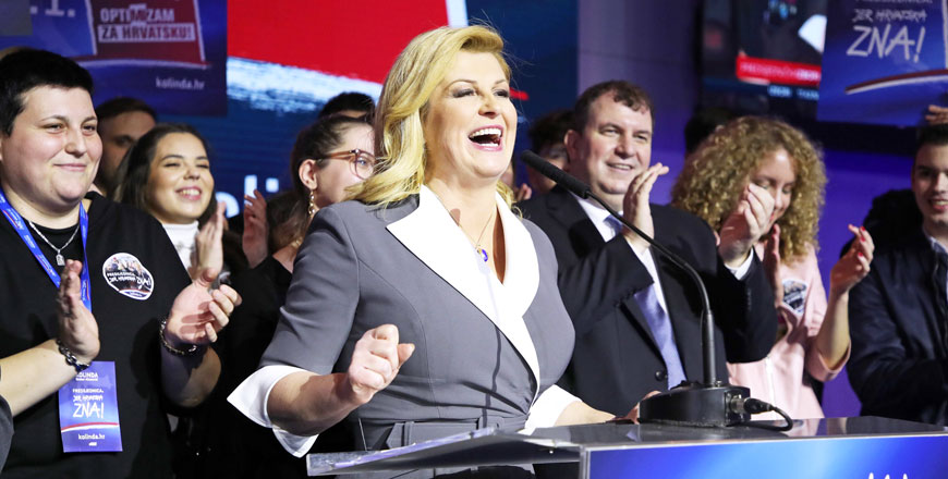 Presidential candidate of the Croatian Democratic Union Party Kolinda Grabar-Kitarovic (centre) gives a speech next to her husband Jakov Kitarovic (centre-right) after the first results of the Croatian presidential elections’ first round on Sunday in Zagreb (AFP photo)