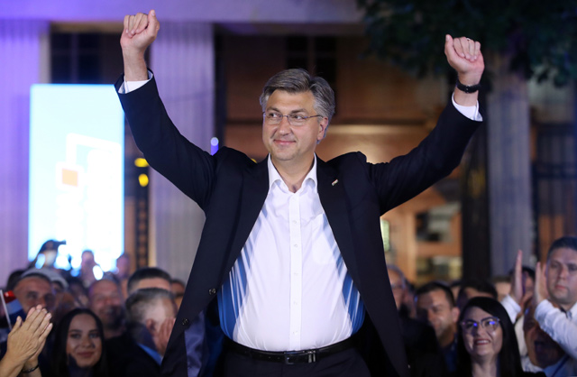 Croatian Prime Minister and leader of the Croatian Democratic Union Party (HDZ) Andrej Plenkovic (centre) celebrates with party members after declaring the victory on parliamentary elections at the garden of the Archaeological Museum in Zagreb, on Sunday (AFP photo)