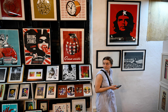 A woman looks at artworks at La Fabrica de Arte Cubano (The Cuban Art Factory) in Havana on March 10 (AFP photo)