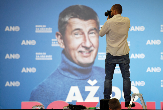 A photographer takes photos of a screen displaying Czech prime minister and leader of the ANO movement, Andrej Babis, at ANO’s election headquarters, during the parliamentary elections in Prague, Czech Republic, on Saturday (AFP photo)