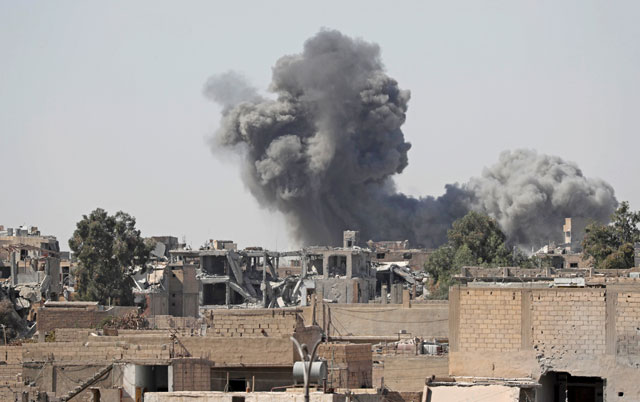 Smoke rises at the positions of Daesh militants after an air strike by the coalition forces at the frontline in Raqqa, Syria, on Thursday (Reuters photo)