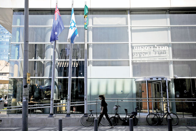 The national flags of Australia and Israel are seen outside the building housing the Australian embassy in Tel Aviv, Israel, on Tuesday  (Reuters photo)