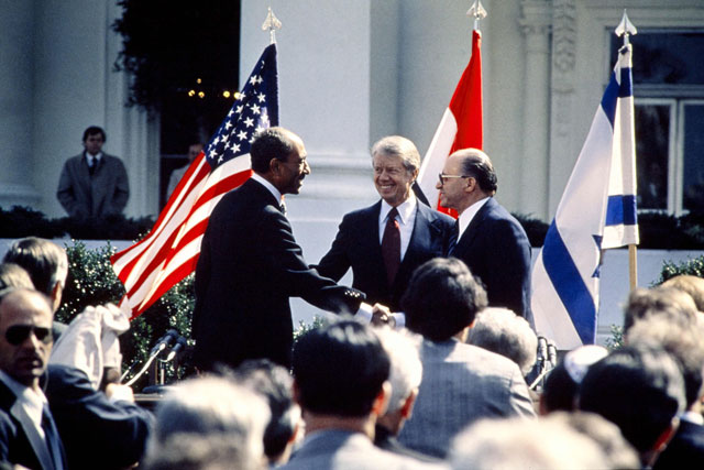 In this file photo taken on March 26, 1979, US president Jimmy Carter (centre) congratulates Egyptian president Anwar Al Sadat (left) and Israeli premier Menachem Begin (right) as they shake hands on the north lawn of the White House, Washington, DC, after signing the historic US-sponsored peace treaty between Israel and Egypt (AFP file photo)