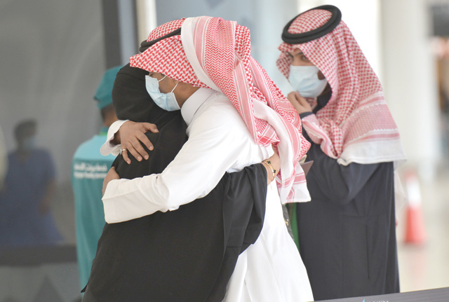 A man embraces his sister who just arrived to the King Khalid International Airport in the Saudi capital Riyadh on the first commercial flight from Qatar, on Monday (AFP photo)