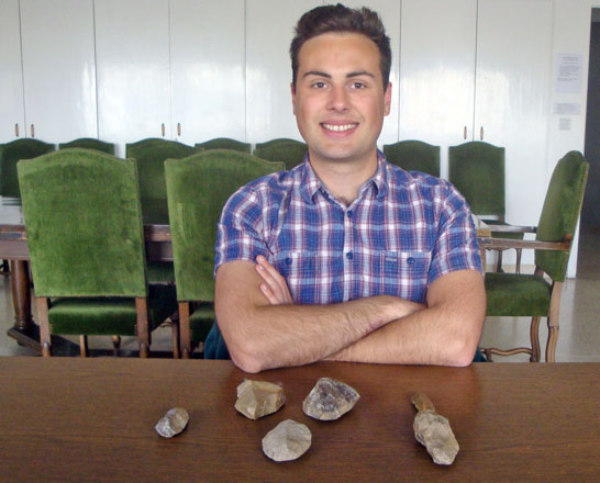Adam Valka with a selection of flaked-stone bifaces and burins excavated from the Early Natufian site of Wadi Hammeh 27 (Photo by Saeb Rawashdeh)