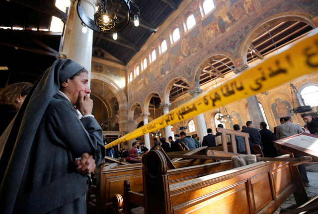 A nun cries as she stands at the scene inside Cairo’s Coptic cathedral, following a bombing, in Egypt on Sunday (Reuters photo)