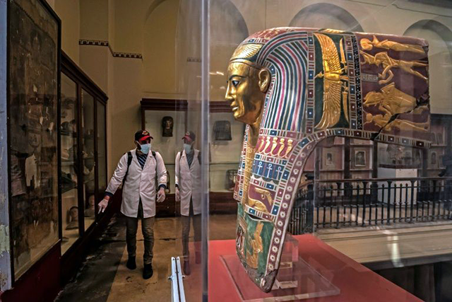 A worker disinfects a gallery at the Egyptian Museum in Cairo's Tahrir Square amid the coronavirus COVID-19 pandemic (AFP photo)