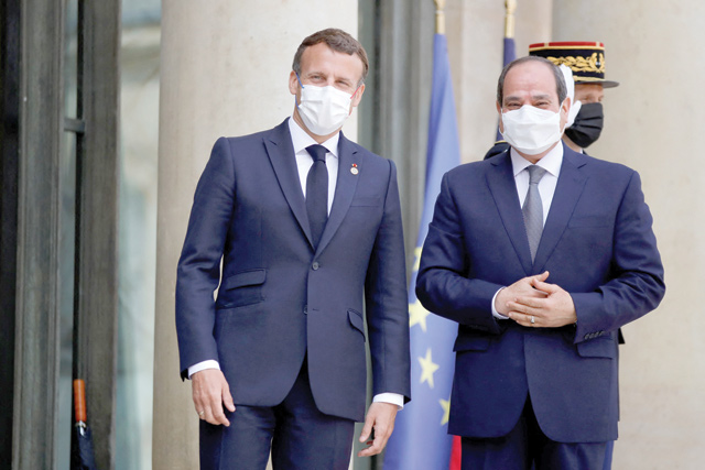 French President Emanuel Macron (left) welcomes Egyptian President Abdel Fattah Al Sisi  as he arrives at the Elysee Palace on Tuesday (AFP photo)