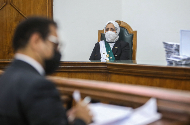 Egyptian female Judge Radwa Helmi Ahmad sits on her first court hearing at the State Council in the capital Cairo, on Saturday (AFP photo)