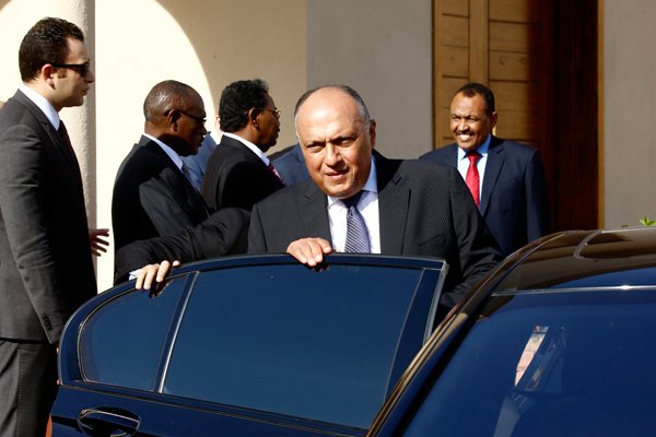 Egyptian Foreign Minister Sameh Shukri boards a car after a meeting with Sudan's president in the capital Khartoum on Thursday (AFP photo)
