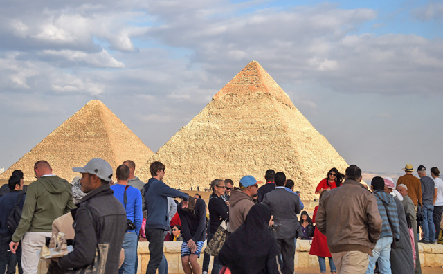 Tourists gather at the Giza pyramids necropolis, on the southwestern outskirts of the Egyptian capital Cairo on Saturday, with the pyramids of Khafre (right) and Khufu seen in the background (AFP photo)