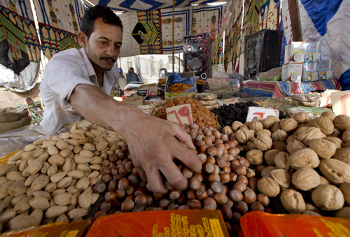 In this June 14 photo, an Egyptian vendor arranges his goods at a market in the neighbourhood of Sayeda Zeinab in Cairo, Egypt (AP photo)