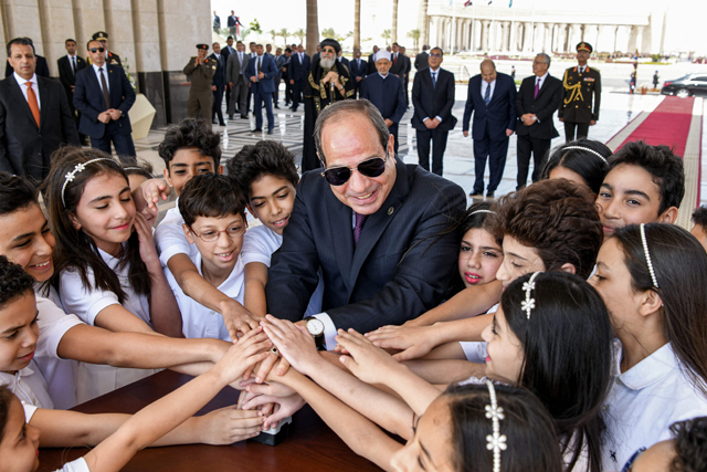 This handout photo released by the Egyptian Presidency shows Egypt’s President Abdel Fattah Al Sisi being greeted by children during his inauguration for a third presidential term at the New Administrative Capital, about 45 kilometres east of Cairo, on Tuesday (AFP photo)