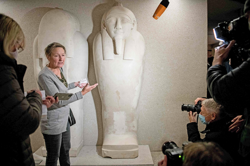 In this file photo Friederike Seyfried, director of the Egyptian Museum Berlin, points to the damage caused by an ‘oily liquid’ leaving visible stains on exhibits in the Egyptian part of the Neues Museum on October 21, 2020, in Berlin (AFP photo)