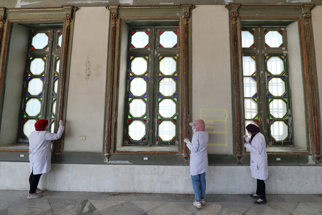 Workers paint window frames during the restoration of Mohamed Ali Shubra Palace in the Egyptian capital Cairo on Thursday (AFP photo)